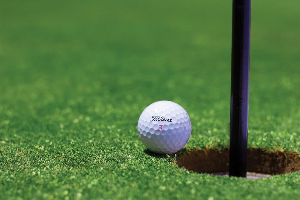 Golf ball and flagstick on a green